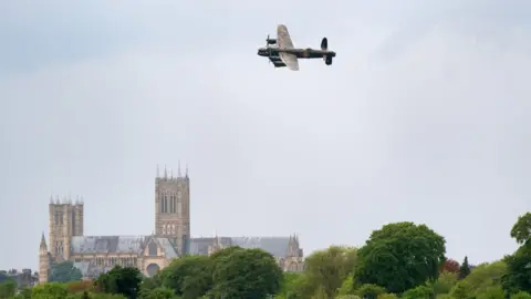 Joe Giddens/PA Lancaster Bomber PA474 passes over Lincoln Cathedral