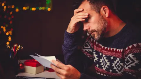 Kerkez/Getty Images Man with tax letter (generic)