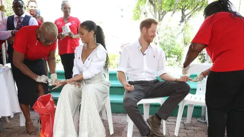 Getty Images Rihanna and Prince Harry taking a HIV test