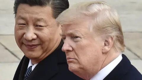 Getty Images File photo taken in November 2017 shows US President Donald Trump (R) and Chinese President Xi Jinping attending a welcome ceremony in Beijing