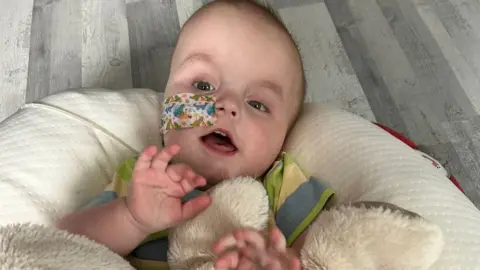 Rachel Mead A baby lying on his back