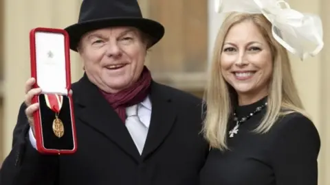 Reuters The musician was accompanied by his daughter Shana Morrison at Buckingham Palace