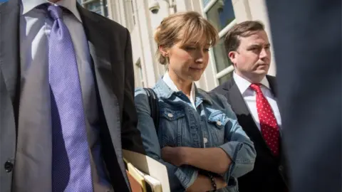 Getty Images Allison Mack exiting court house with lawyers