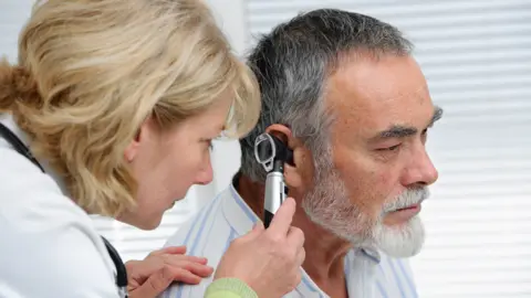 AlexRaths/Getty Images Deaf person is examined by GP