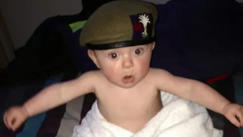 Family photo Ollie as a baby in an army beret