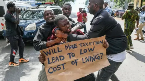 Getty Images Kenyan plain clothed police officers detain an activist during a protest over tax hike plans in Nairobi on June 6, 2023.