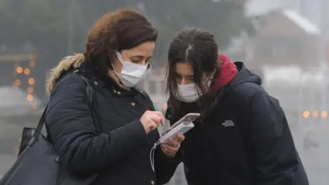 Getty Images Women in Ukraine using a mobile phone