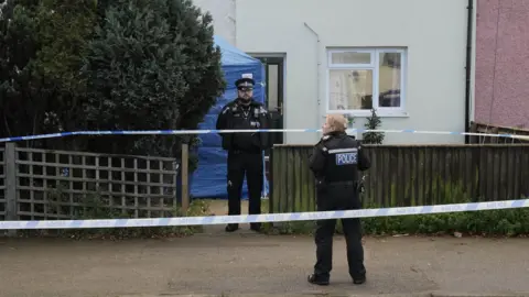 John Fairhall/BBC Police cordon outside a property on Exning Road