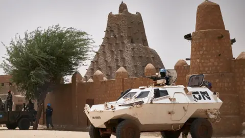 AFP United Nations vehicles patrol in front of the mosque Sankore in Timbuktu on March 31, 2021. - A symbolic euro was handed over to the government of Mali and UNESCO for damage inflicted by Islamists who wrecked Timbuktu's World Heritage-listed mausoleums in 2012.