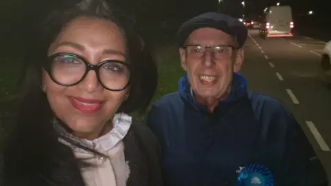 Pinder Chauhan Pinder Chauhan in the street with a Conservative supporter