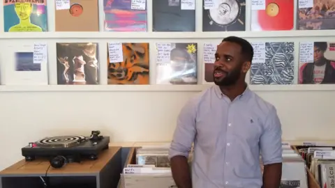 man stands in record shop