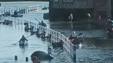 Chris Riches Blakeney in flood and people in kayaks