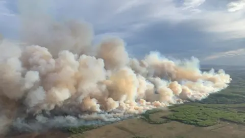Smoke rises from mutual aid wildfire GCU007 in the Grande Prairie Forest Area near TeePee Creek, Alberta
