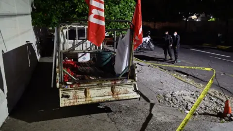 Getty Images Police guard a truck that carried supporters of the political party Farabundo Marti Front (FMLN)