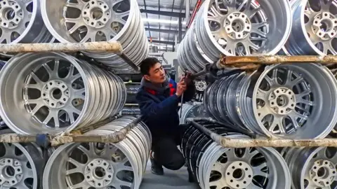 Getty Images A factory worker with wheels in a Chinese factory