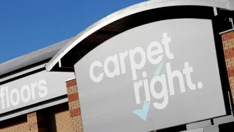 Reuters Sign outside Carpetright store