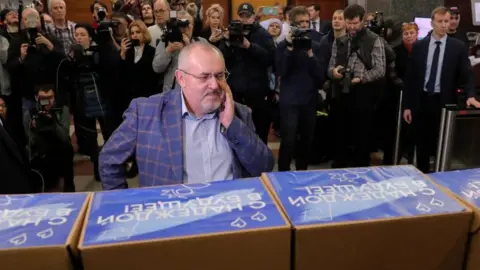 EPA Boris Nadezhdin stands in front of boxes with journalists and camera people behind him at Central Election Commission, Moscow, Russian Federation on 31 Jan 2024