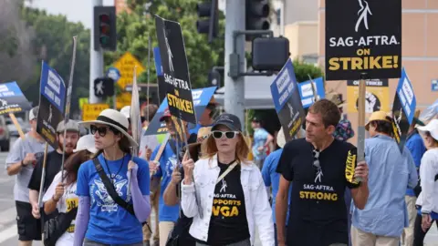 Getty Images LOS ANGELES, CALIFORNIA - SEPTEMBER 28: Marg Helgenberger (C) joins the picket line outside Fox Studios on September 28, 2023 in Los Angeles, California. The WGA (Writers Guild of America) has reached a deal with Hollywood studios after 146 days on strike, ending the strike at midnight on September 27. Members of SAG-AFTRA and WGA (Writers Guild of America) walked out in their first joint strike against the studios since 1960, shutting down a majority of Hollywood productions. SAG-AFTRA has not reached a deal with the studios and has been on strike since July 14. (Photo by David Livingston/Getty Images)