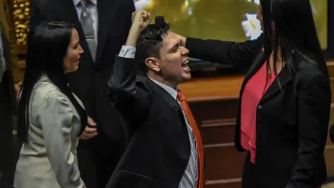 Getty Images Rosmit Mantilla gestures after receiving his credentials as a legislator in Venezuela's National Assembly in November 2016