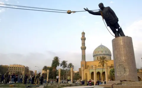 Getty Images US troops topple a statue of Saddam Hussein in Baghdad, 9 April 2003