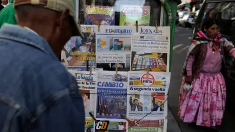 AFP People read front pages of newspapers after the presidential election, in La Paz, Bolivia, on October 21, 201