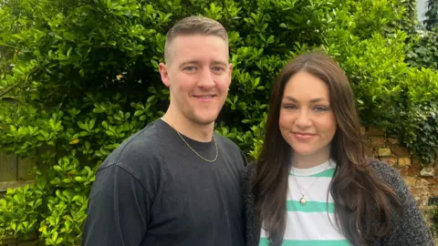 Harry and Lauren Fox standing in their garden