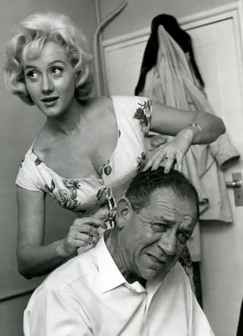 Alamy Liz Fraser taking scissors to the hair of Carry On co-star Sid James