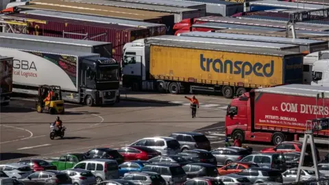 Getty Images Lorries being directed at