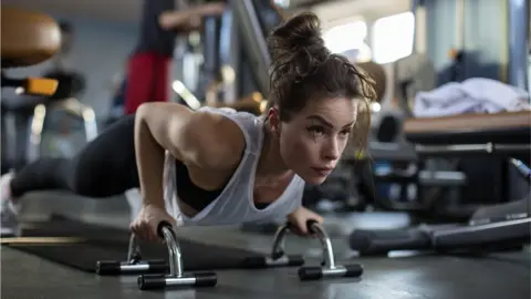 Getty Images Woman working out at gym