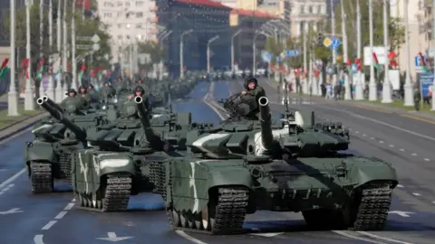 Reuters Belarusian servicemen drive tanks along the street before a rehearsal for the Victory Day parade on 8 May