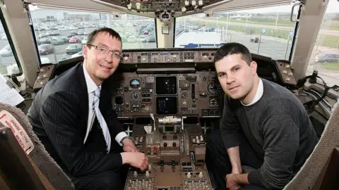 Getty Images Managing director of Monarch Airlines and Dan Baxter, General Manager of Hed Kandi pose in the cockpit as they unveil a Monarch Airlines Boeing 757 emblazoned with the Hed Kandi logo at Luton Airport on April 27, 2007