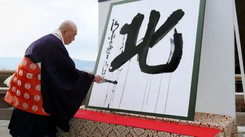 AFP Seihan Mori, master of the ancient Kiyomizu temple, uses an ink-soaked calligraphy brush to write the Chinese character, known as kanji, for 'North' at the temple in Kyoto on December 12, 2017, as a defining symbol of 2017.
