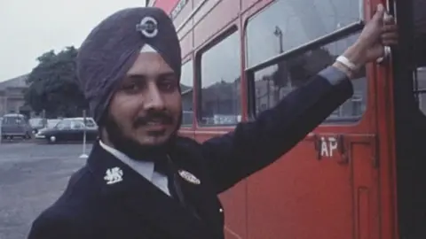 BBC Tarsem Singh Sandhu, wearing his turban with his bus driver's uniform