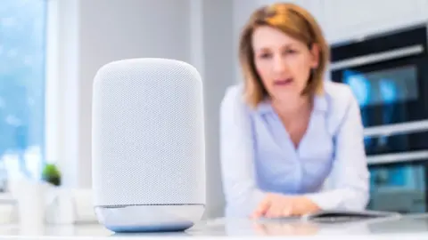 Getty Images Woman using AI speaker