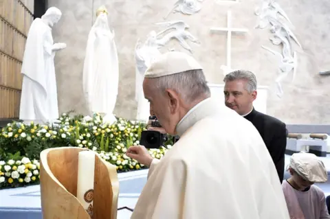 AFP Pope Francis lights a candle at the Knock shrine