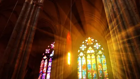 Getty Images Stained glass windows in a church.