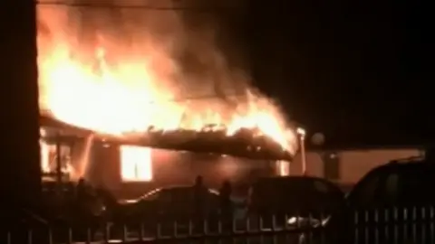 A still of TV footage of the house fire