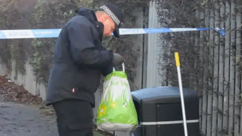 PA Police officer checking bins