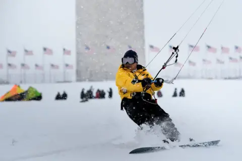 AFP A man kite surfs in the snow