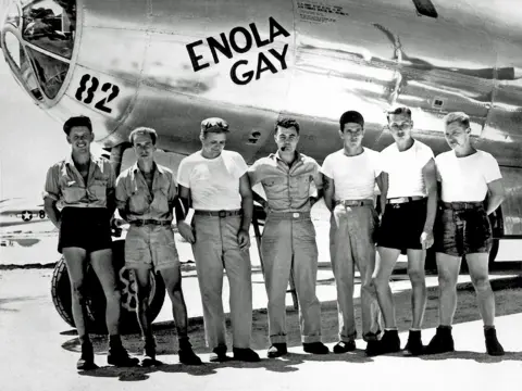 Getty Images The crew of the bomber Enola Gay pose in front of the aircraft