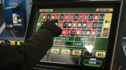 PA A gambler playing on a machine