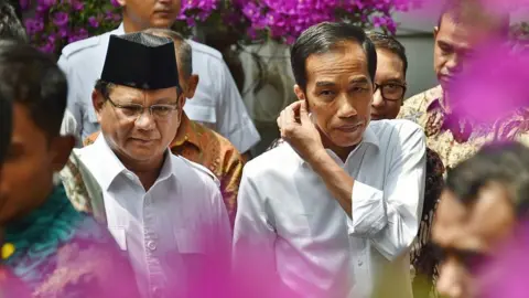 Getty Images Joko Widodo (C) and Prabowo Subianto (L) in 2014