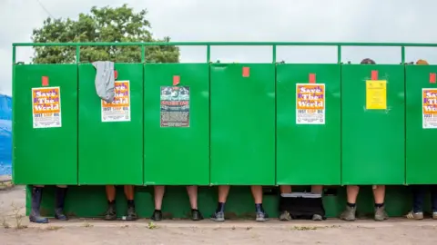 EPA-EFE/REX/Shutterstock Festivalgoers visiting the toilet on the third day of the Glastonbury Festival