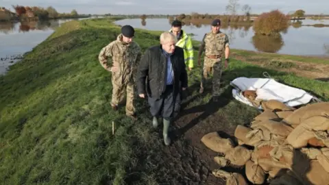 PA Media Boris Johnson with the Army on a visit to flood-hit South Yorkshire