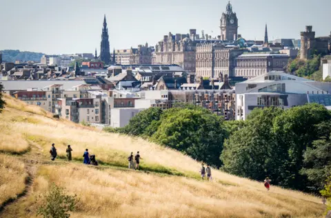 PA Media Grass turned yellow due to dry conditions in Holyrood Park, Edinburgh, Scotland, 10 August 2022.