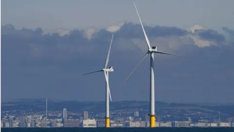 Getty Images Two off-shore turbines near Brighton