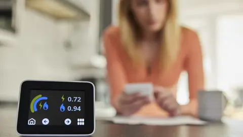 Getty Images smart reader in foreground, woman out of focus at desk in background