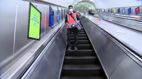 Man testing air on escalator