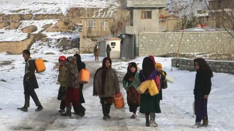 Getty Images Children fetch drinking water during a cold winter day in Yaftal Sufla district of Badakhshan Province, Afghanistan, 18 January 2023