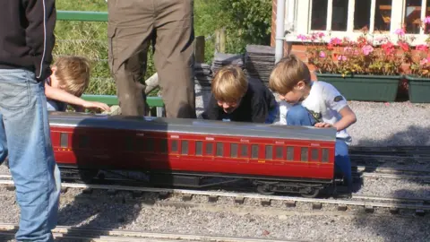 Joe Waddington The Waddington brothers looking at a miniature railway carraigeway